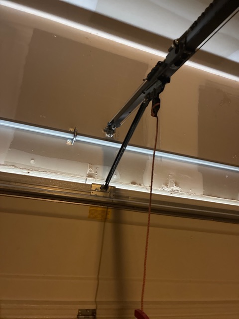 Garage door opener arm and rail detail in New Braunfels TX