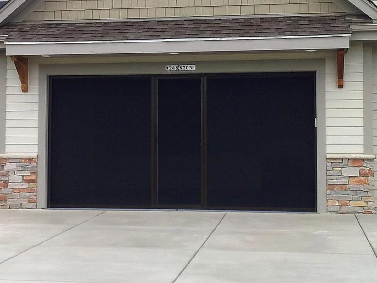 Black-frame Lifestyle retractable garage screen installed on a New Braunfels, TX home