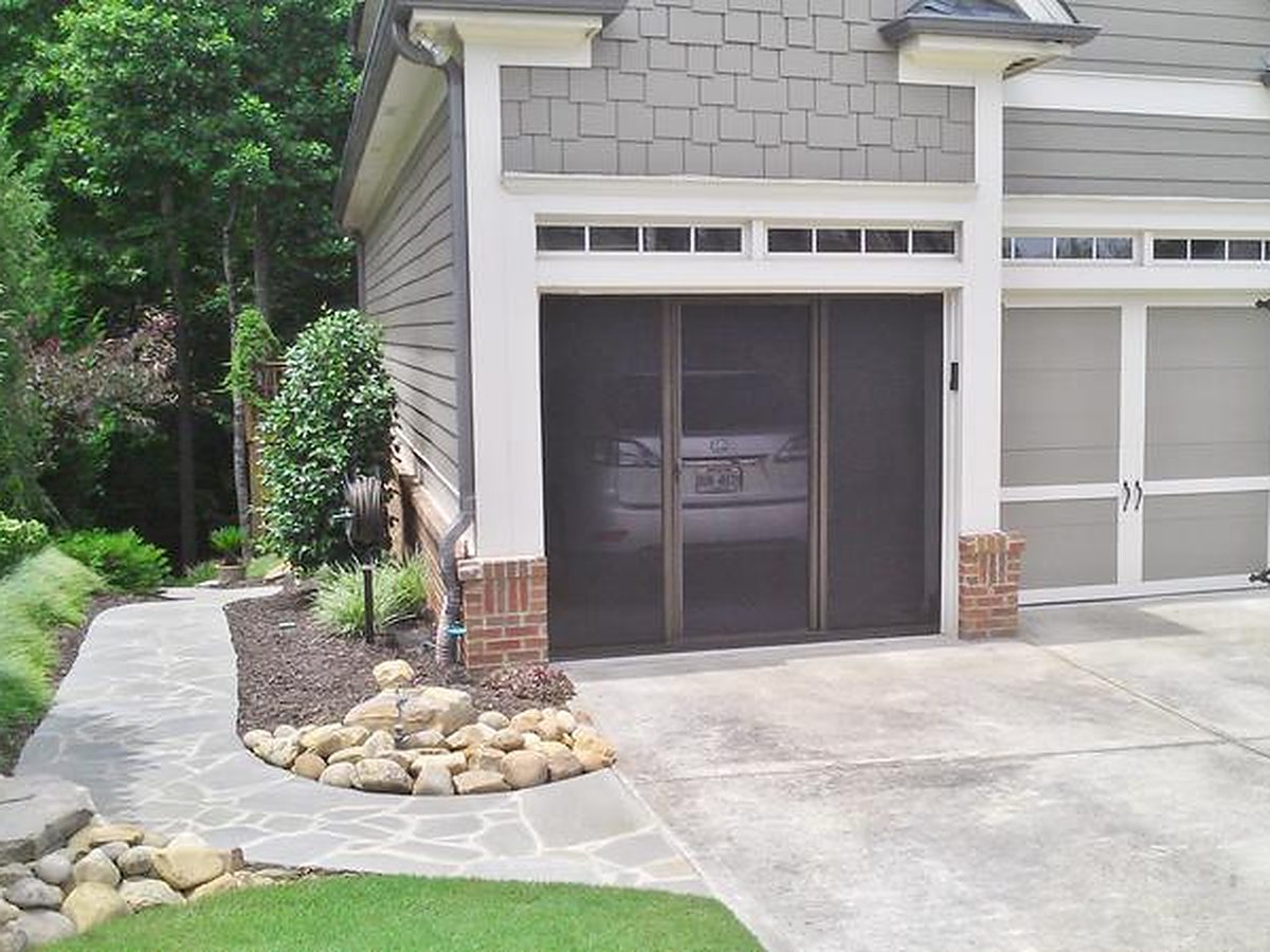 Brown-framed Lifestyle garage screen on a craftsman-style stone and siding garage