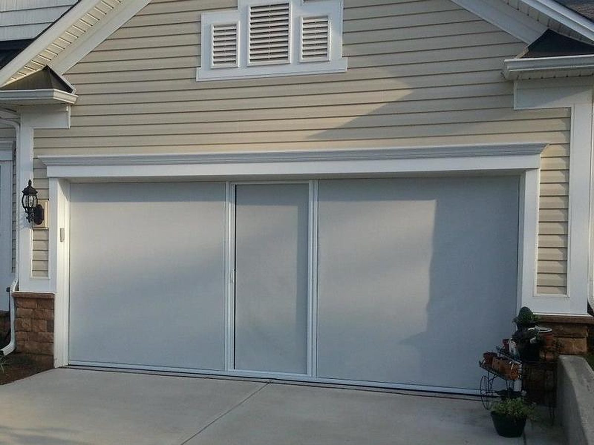 White-framed Lifestyle garage screen with privacy mesh on a gray two-car garage