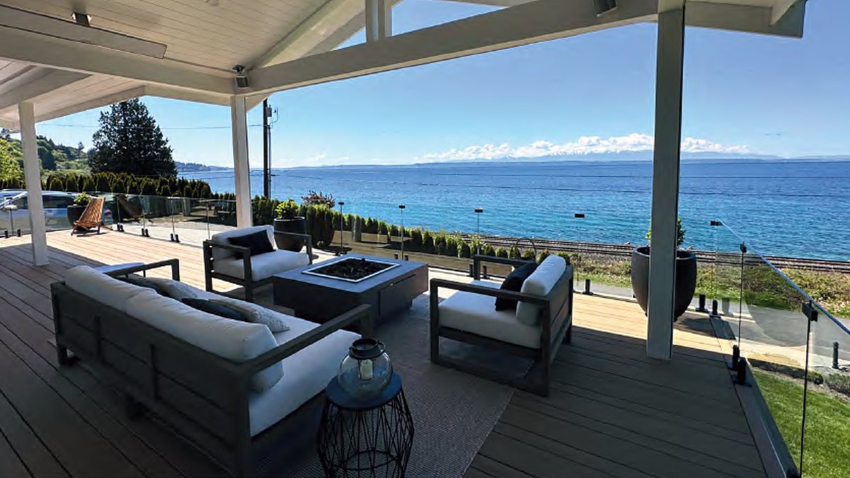 Covered deck with the motorized screen fully retracted into its housing and an open water view