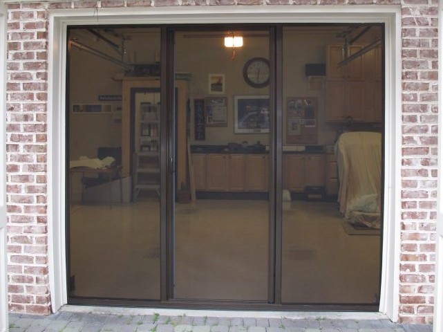Lifestyle garage screen with brown frame and heavy-duty mesh