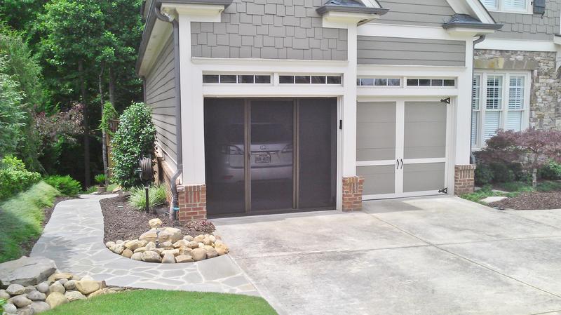 Lifestyle retractable garage screen with brownstone frame installed on a home garage